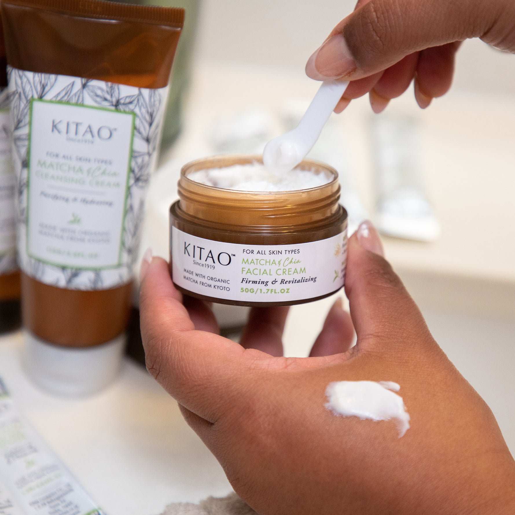 applying Kitao Matcha Facial Cream on a woman's hand